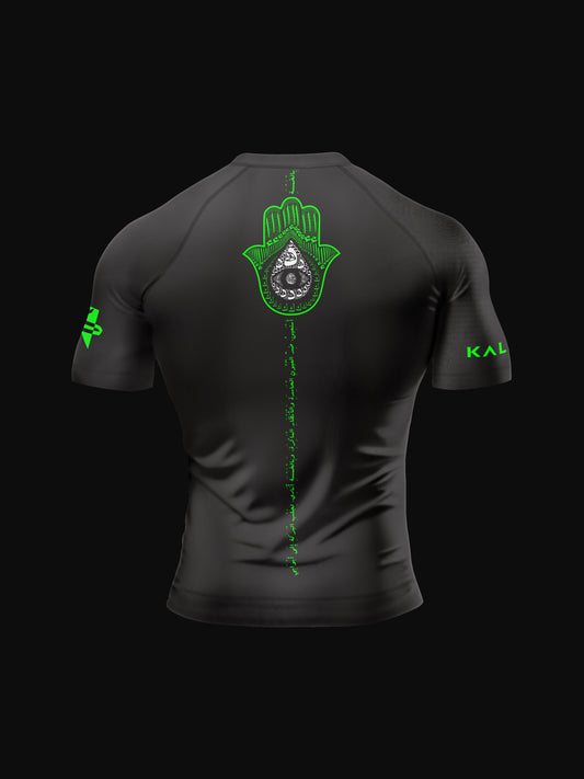 Black rashguard with arabic design, used for jiu-jitsu and other martial arts (e.g. MMA). This product features an exclusive print about khamsa, also known as hamsa, or the hand of Fatima. It is a popular amulet in Middle Eastern and North African culture, and is intended to protect against evil and envy. This art piece and pattern uses beautiful arabic letters and calligraphy to form its attractive shape. Backside view. Yellow and white print color.